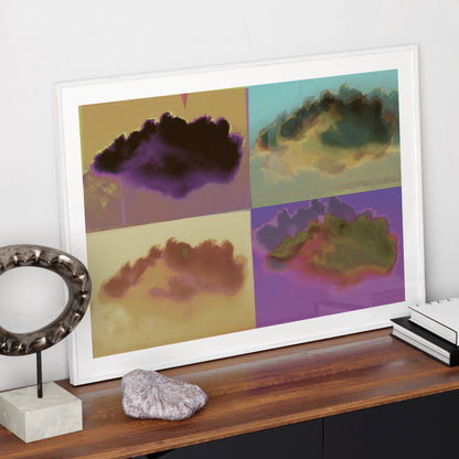 Colorful pop art print with clouds, in a white frame on a modern sideboard.