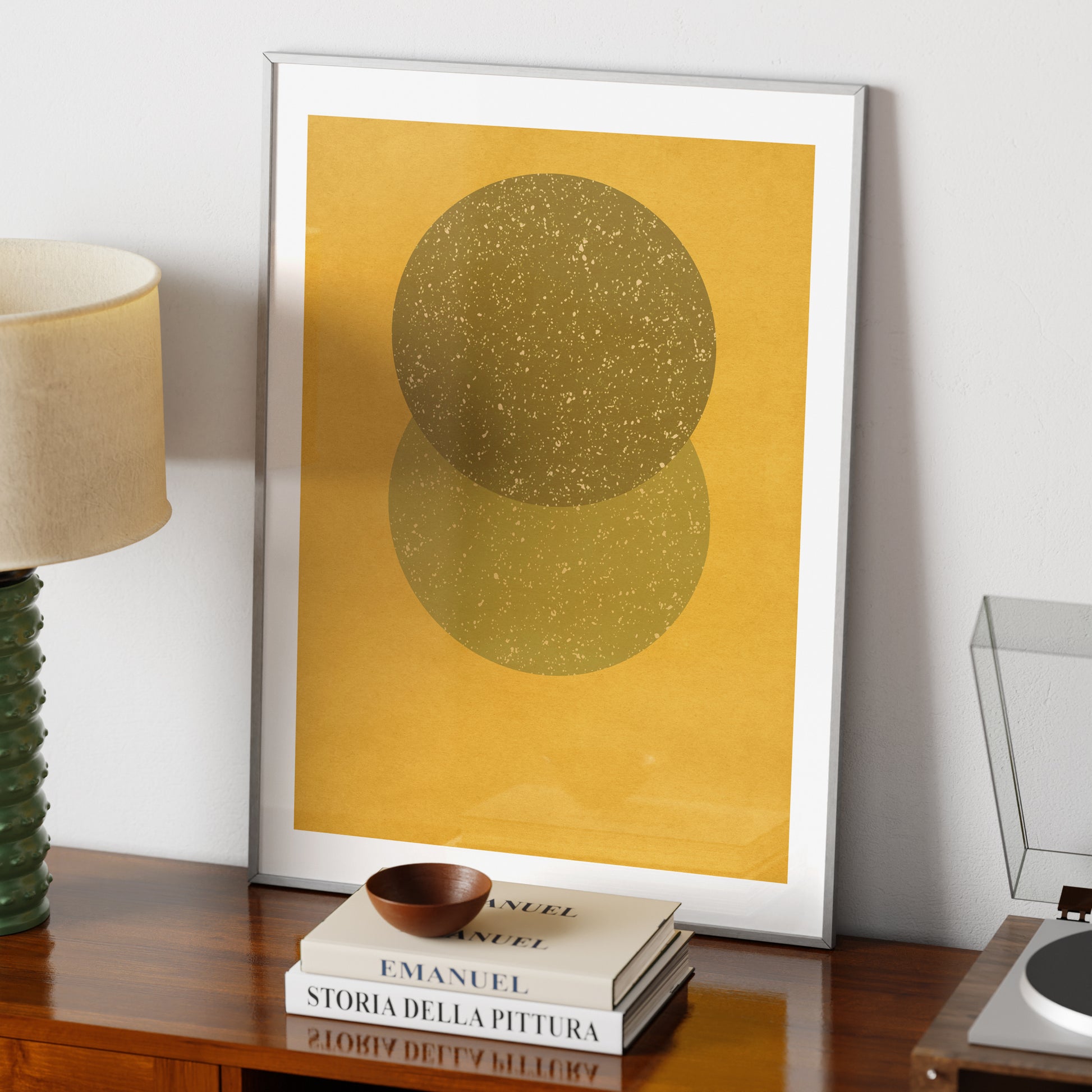 Yellow geometric abstract art print on a vintage sideboard.