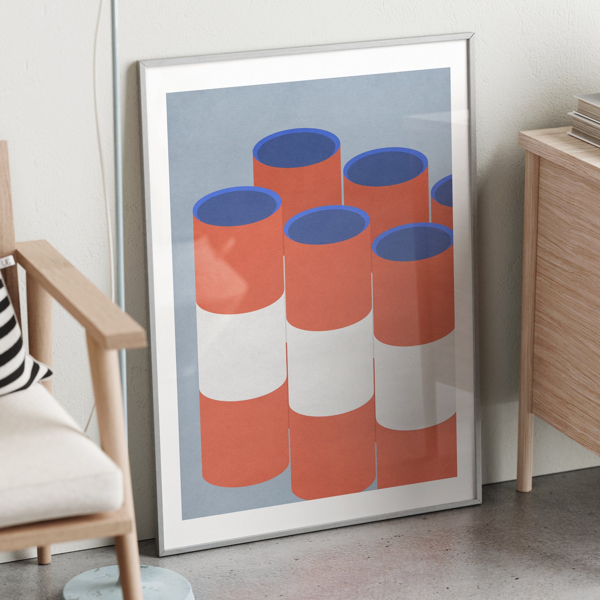 Red and blue graphic art print in a metallic frame.