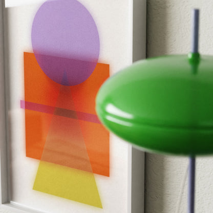 Abstract art with colorful shapes on a white background, green lampshade in foreground