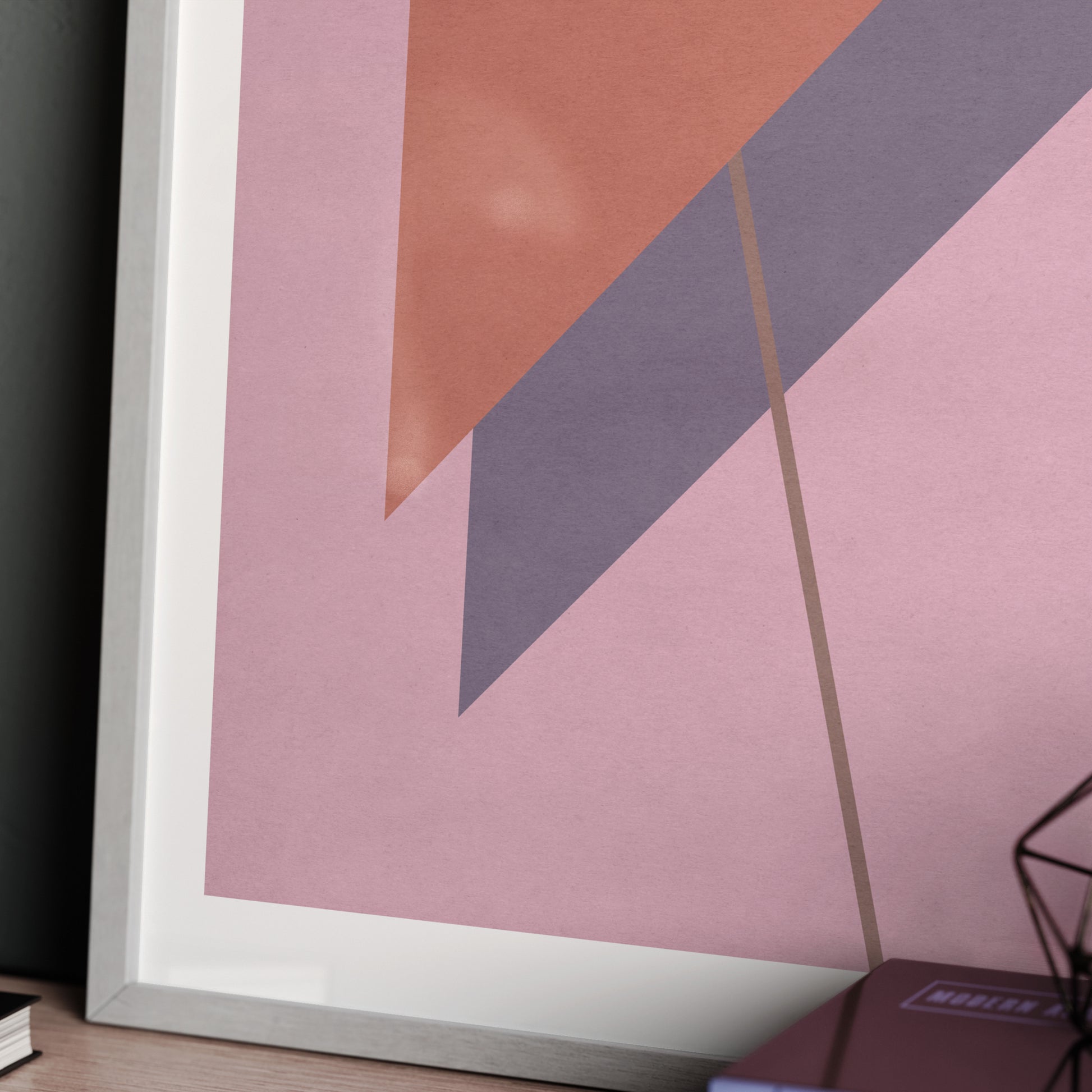 Detail of a pink abstract graphic art print with red and purple triangles.