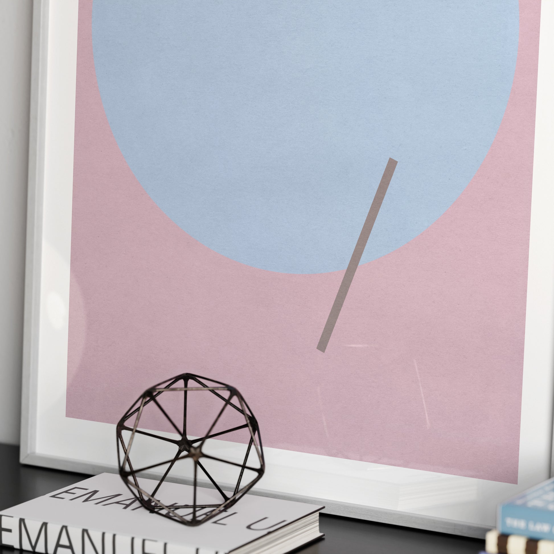 Detail of a pink graphic art print with a blue circle.