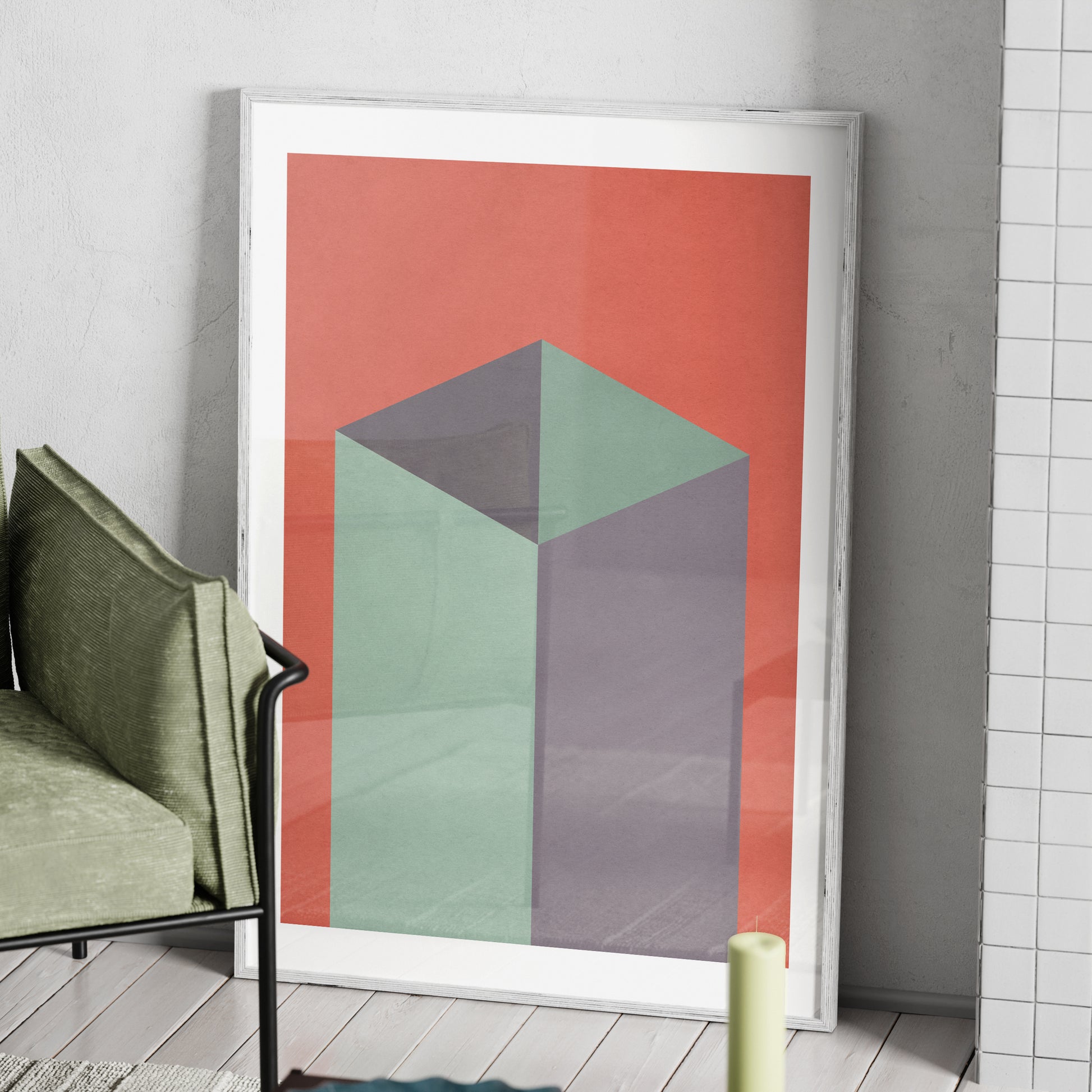 Red and green geometric graphic art print in a white wood frame.