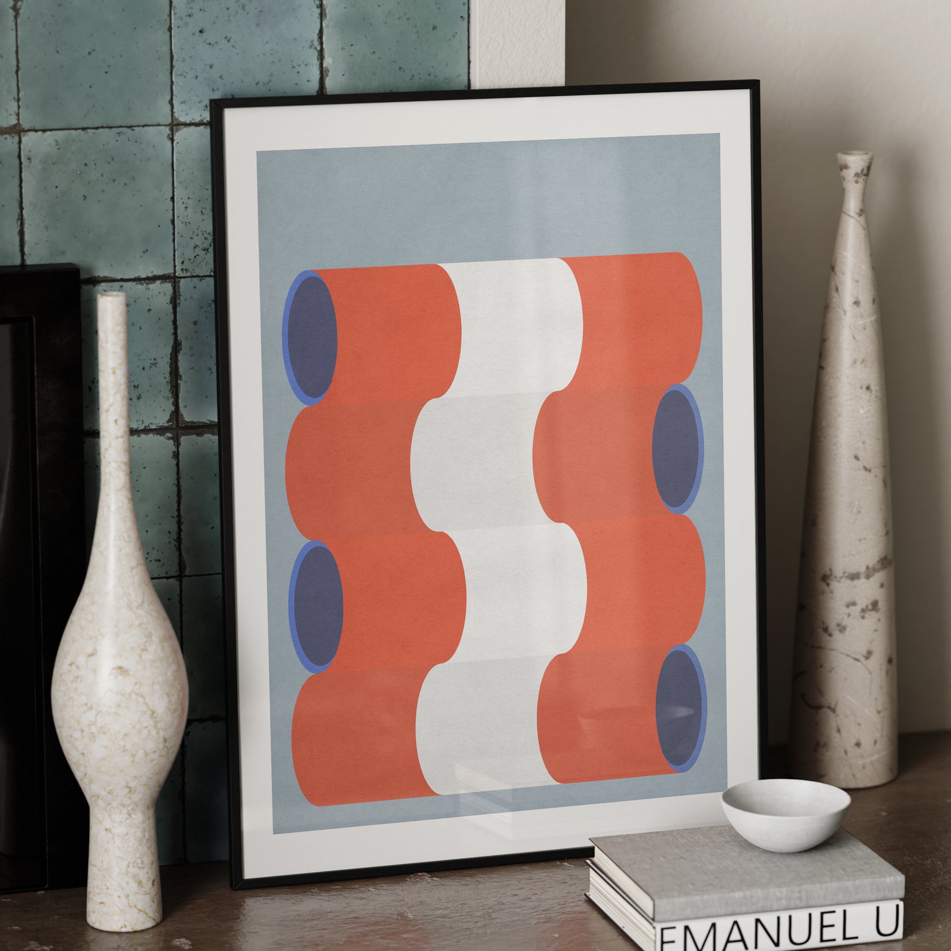 Blue, white and red graphic art print in a black metallic frame.