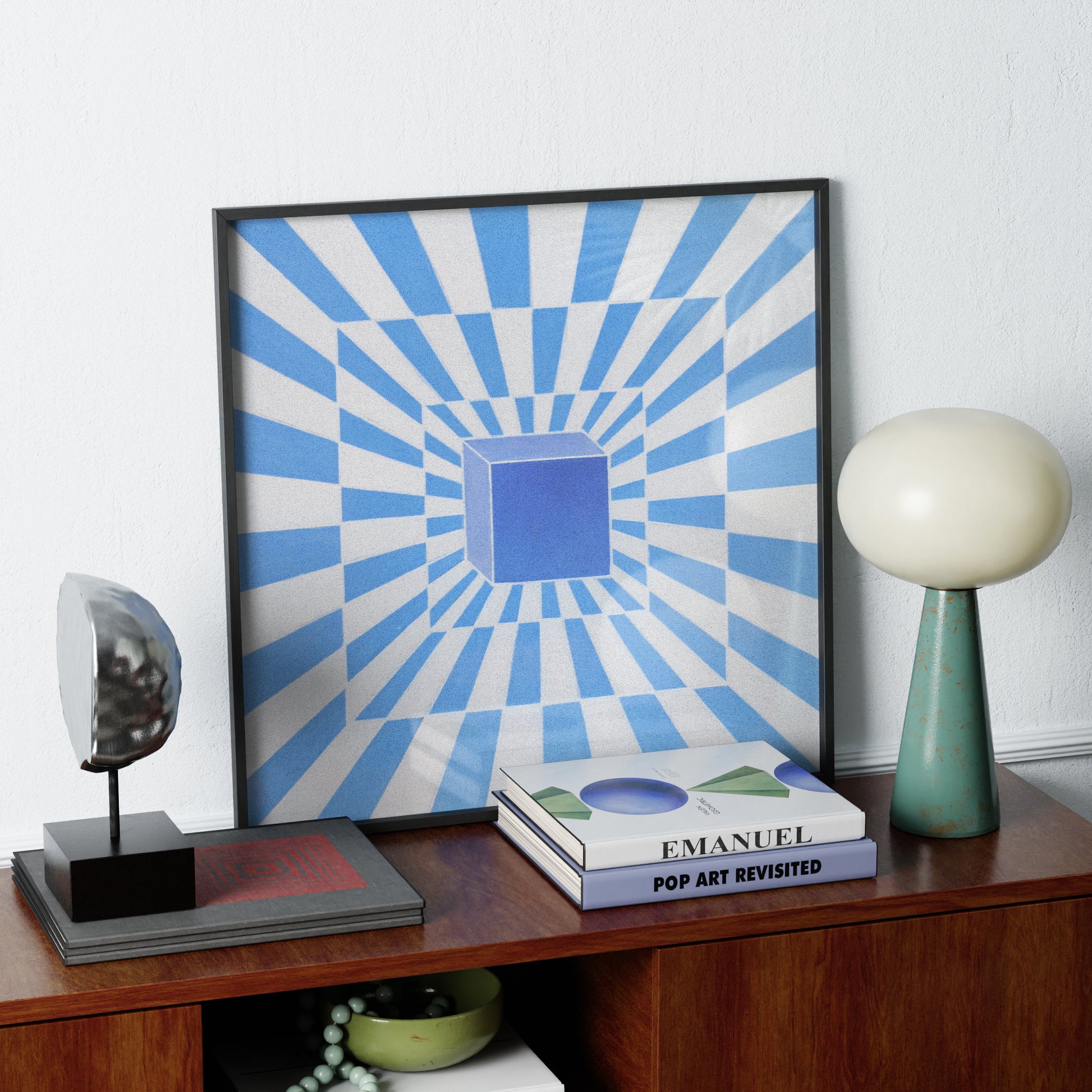 Framed abstract artwork with blue and white stripes on a wooden shelf with decorative items.