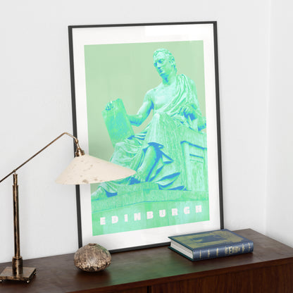 Travel poster Edinburgh landmark green art print on a dark wood sideboard.