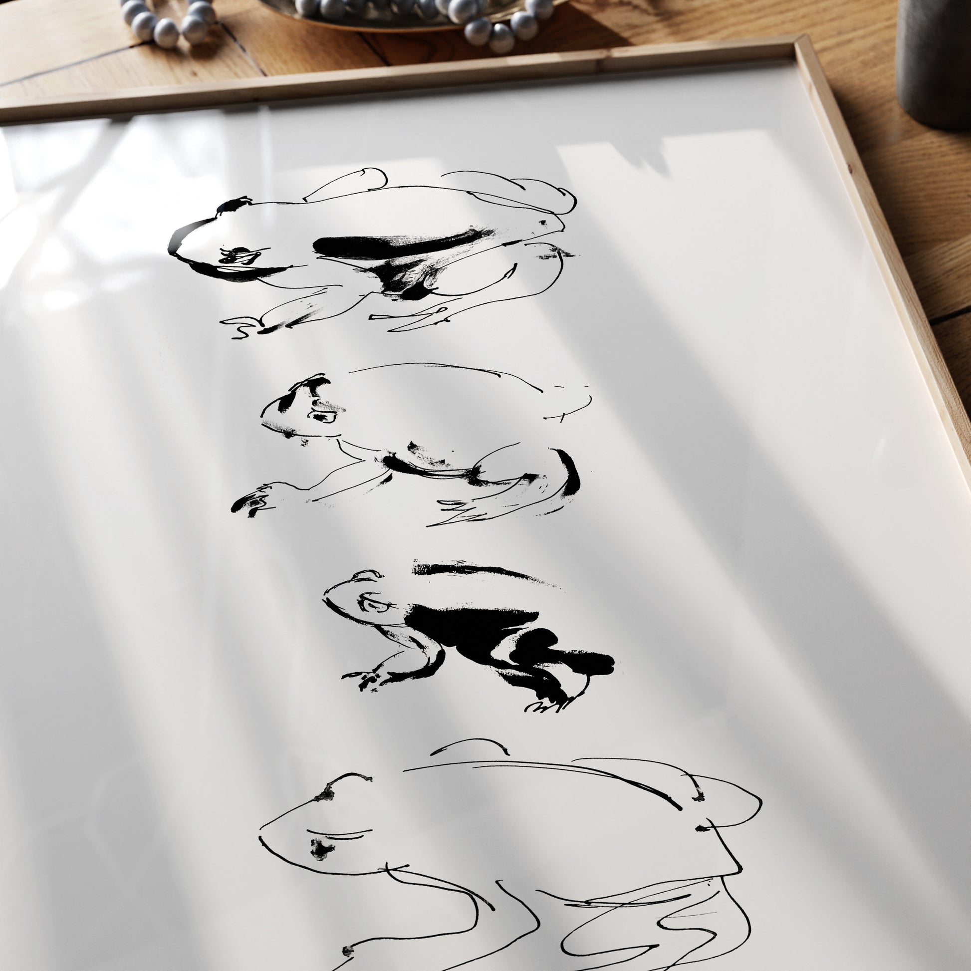 Detail of an art print depicting an ink frog study.