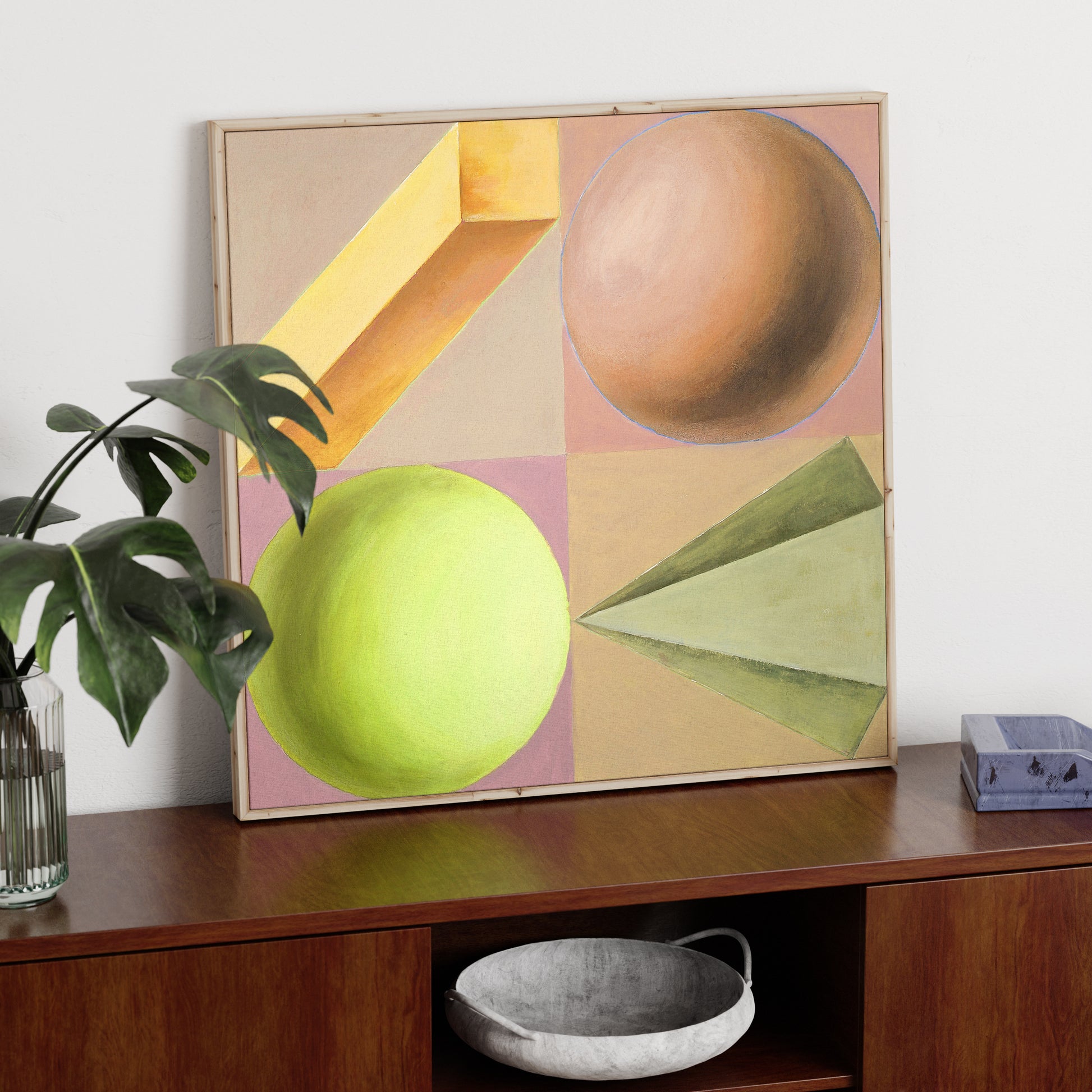 Pastel colors playful geometric shapes art print on a solid wood sideboard.