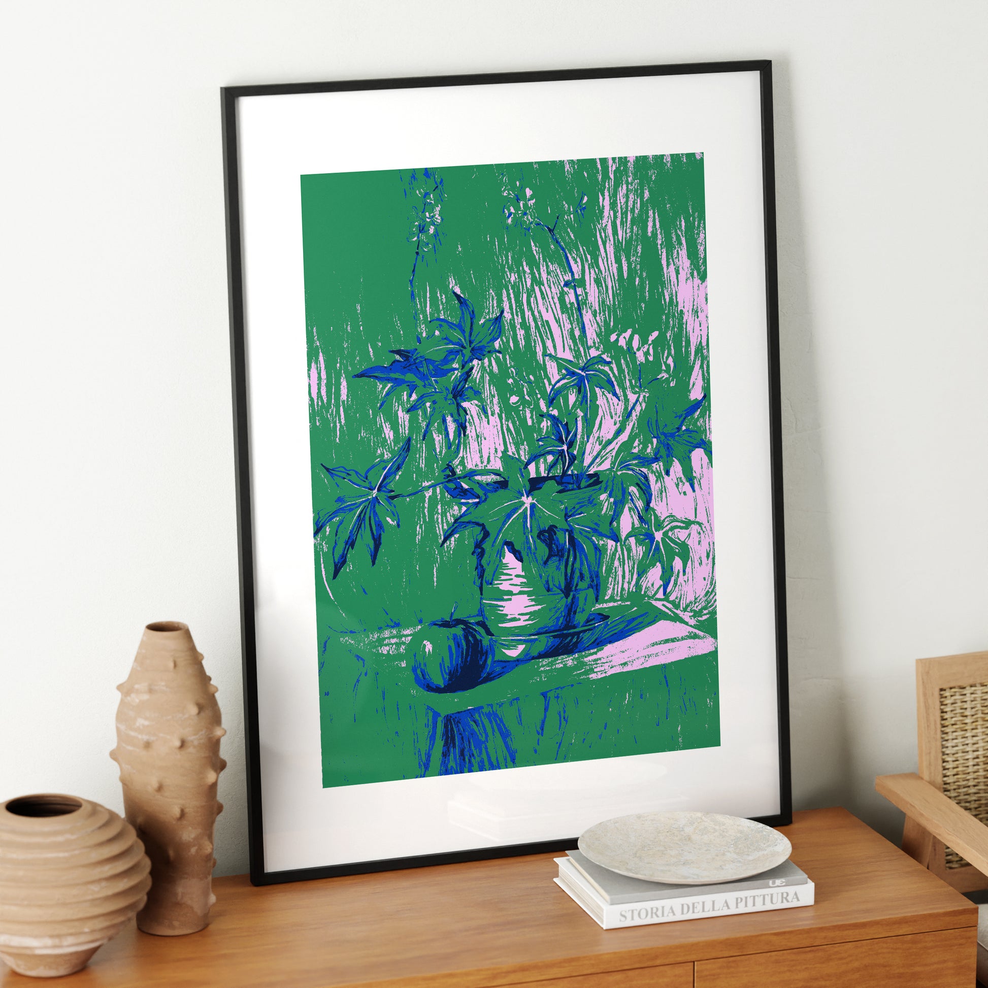 Still life with plant, green graphic art print in a black metallic frame.
