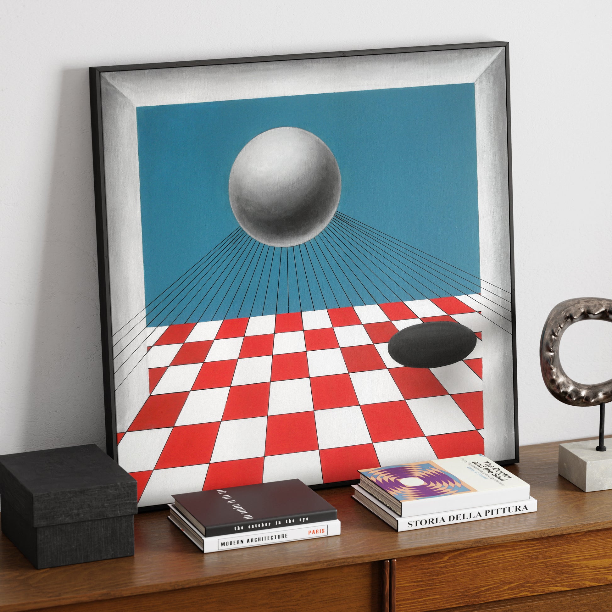 Red and blue geometric contemporary painting on a sideboard.