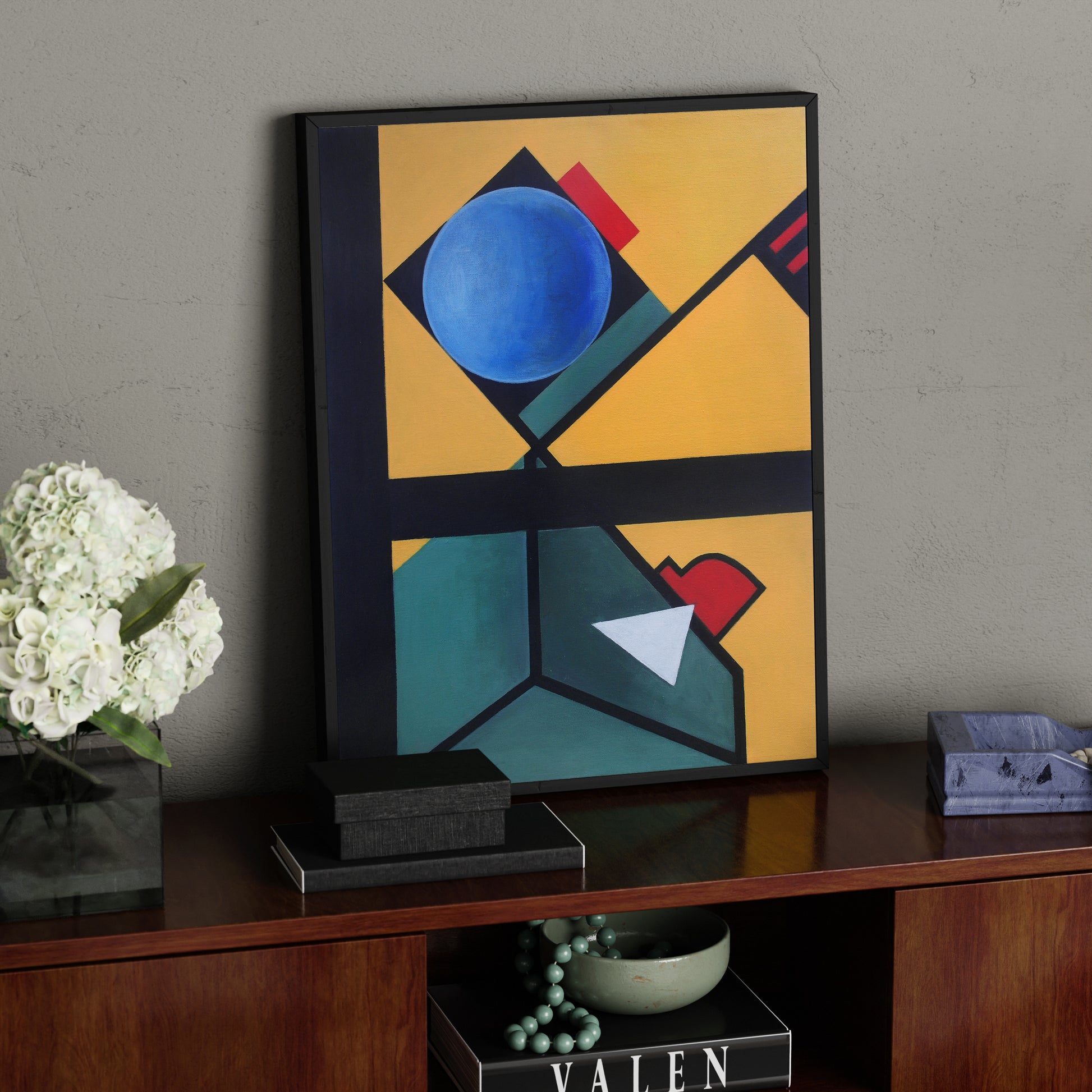 Colorful abstract geometric contemporary painting on a sideboard.