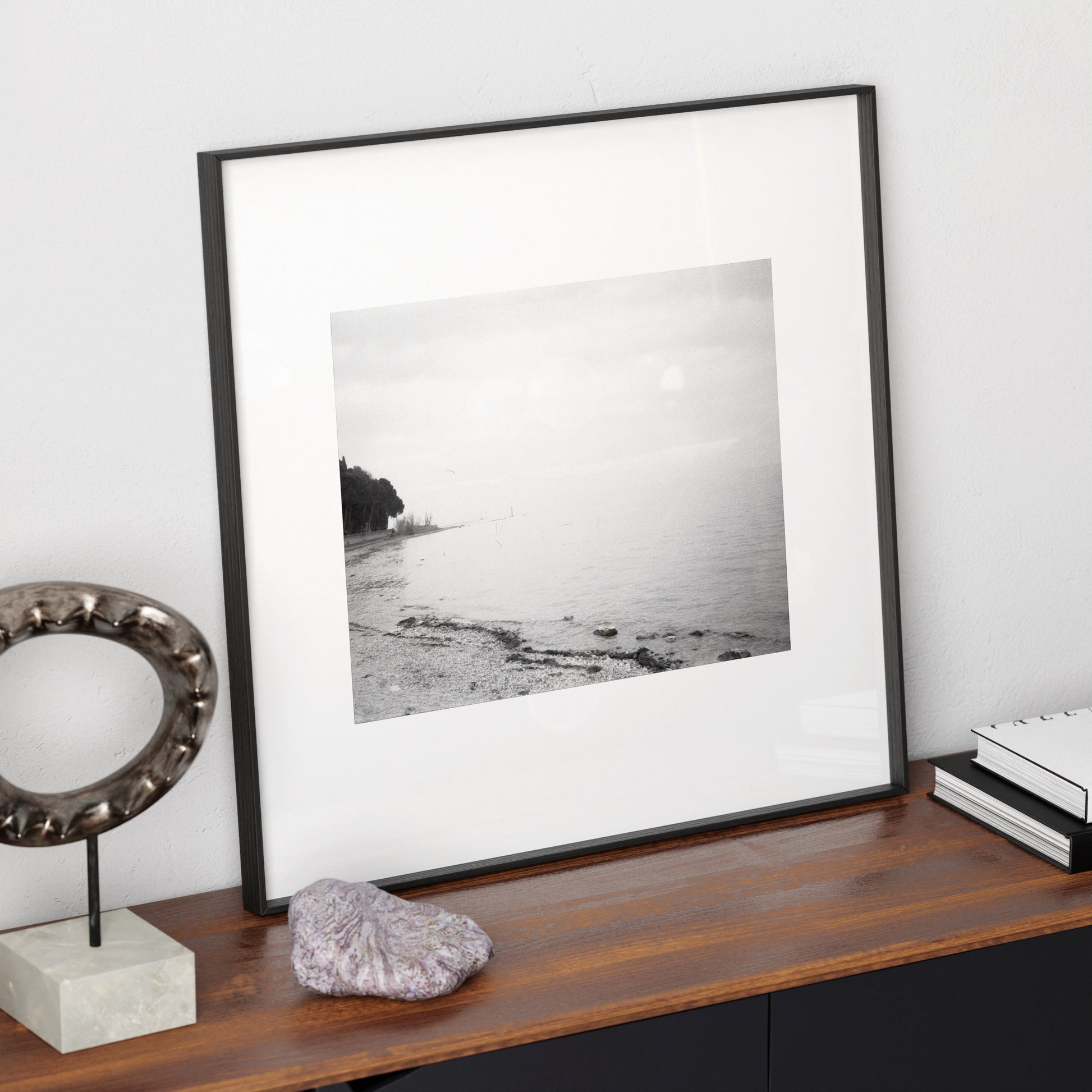 Lake Garda vintage, artistic, moody landscape photography, black and white art print on a modern sideboard.