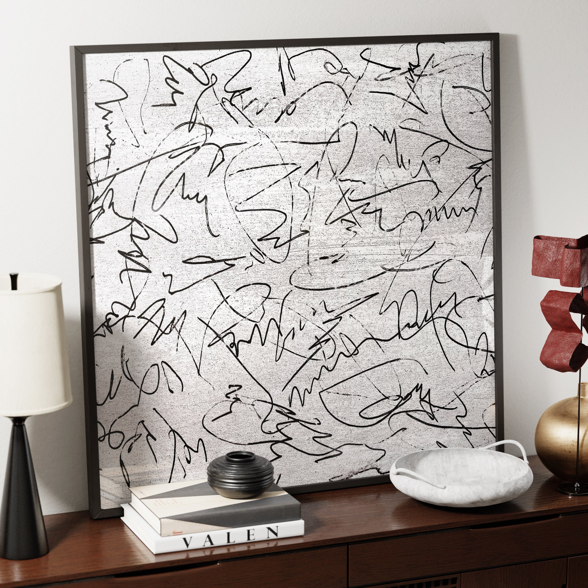 Black and white, abstract lines, contemporary art print on a sideboard.