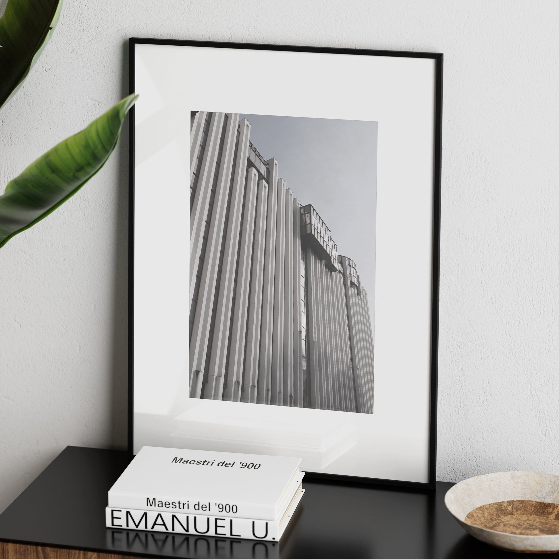 Brutalist, monumental architecture, photography art print on a sideboard.