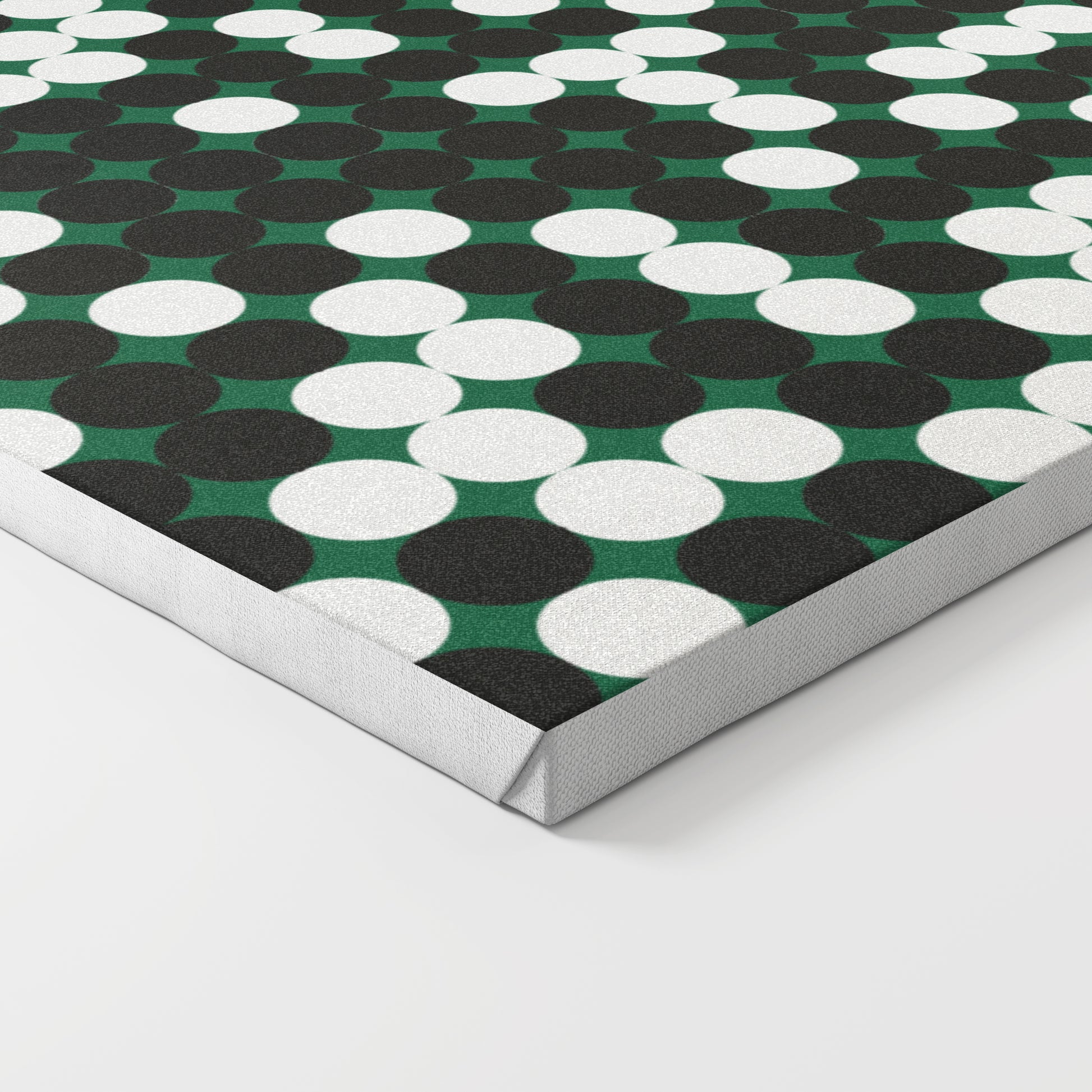 Close-up of a patterned design art print on canvas, with white and black dots on a green background.
