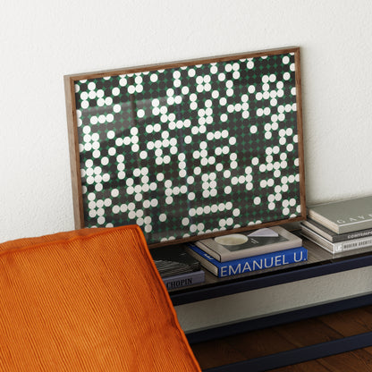 Decorative wall art with a geometric pattern on a shelf with books.