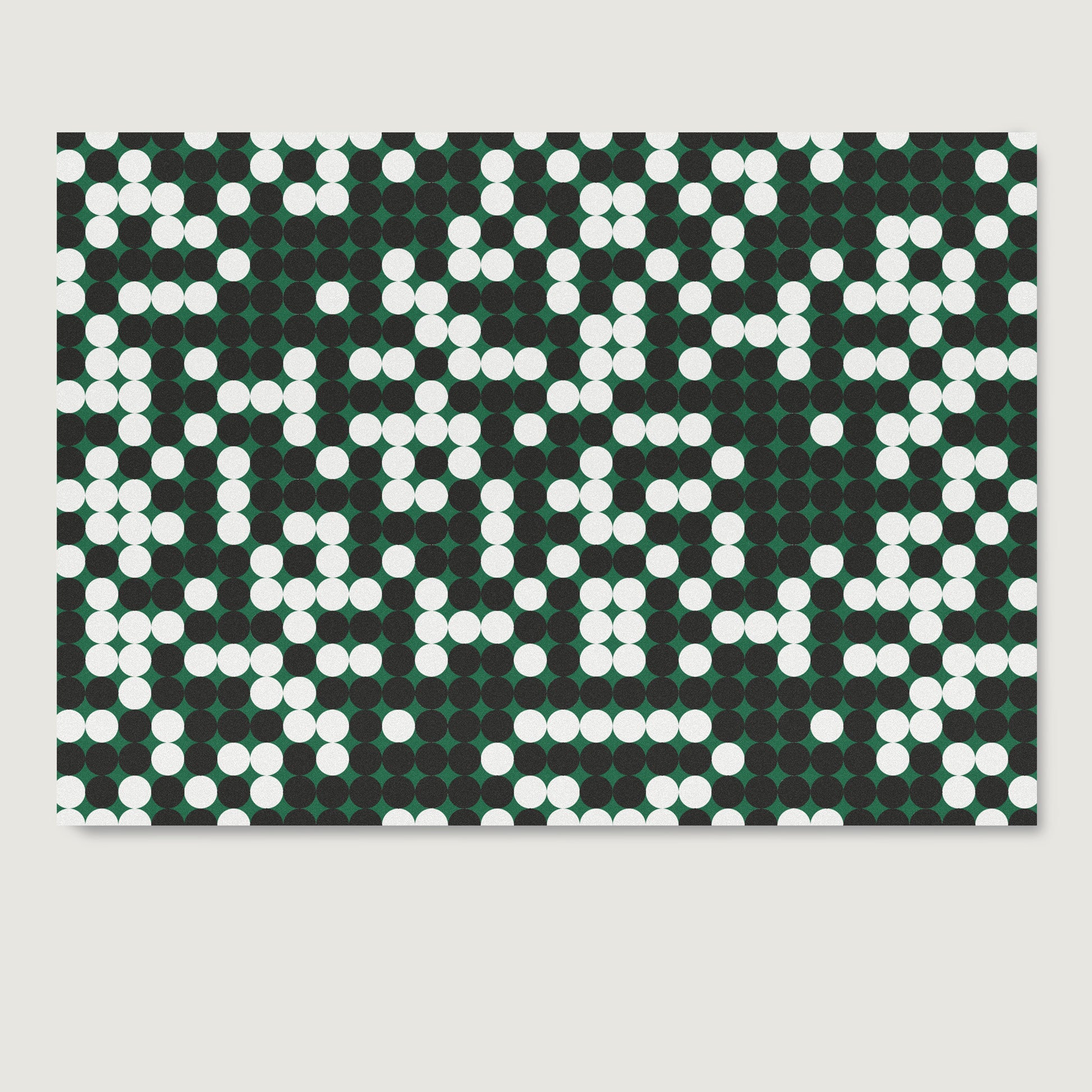 Pattern design art print on paper with white and black dots on a green background.
