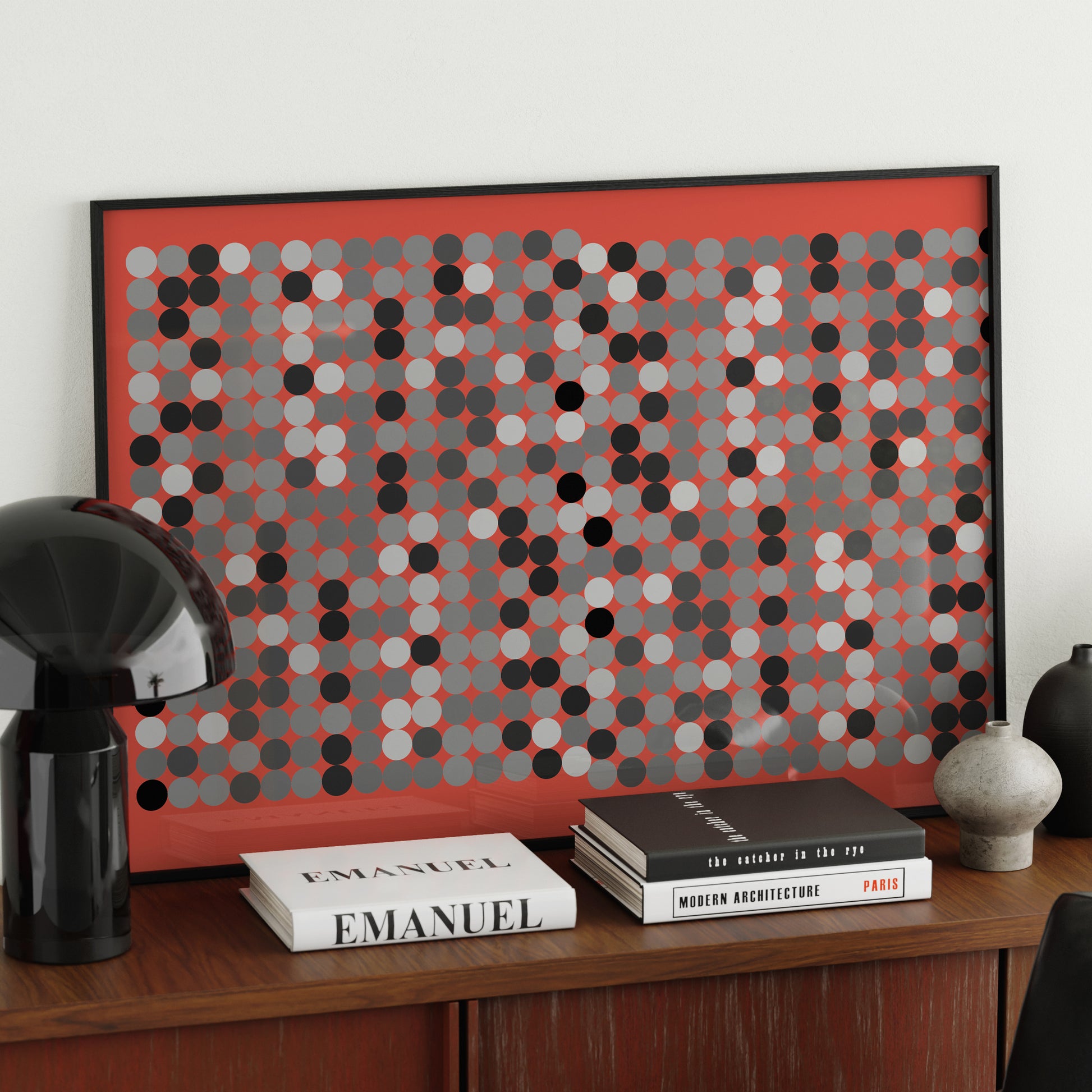 Black and white dots on a red background, contemporary graphic art print, on a red sideboard.