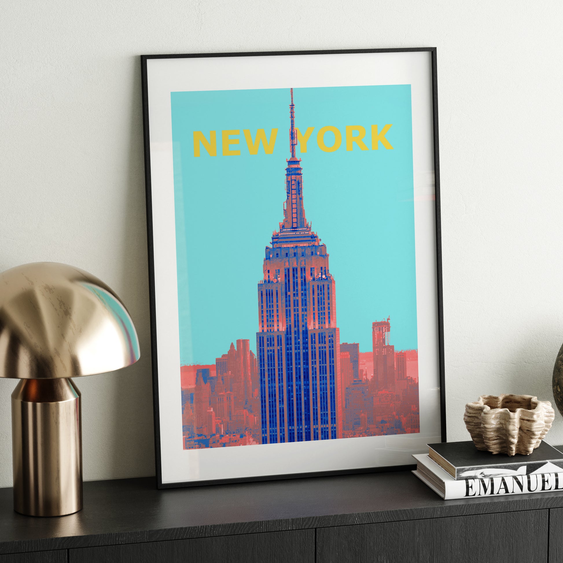 Travel poster New York landmark art print, on a dark wood sideboard.