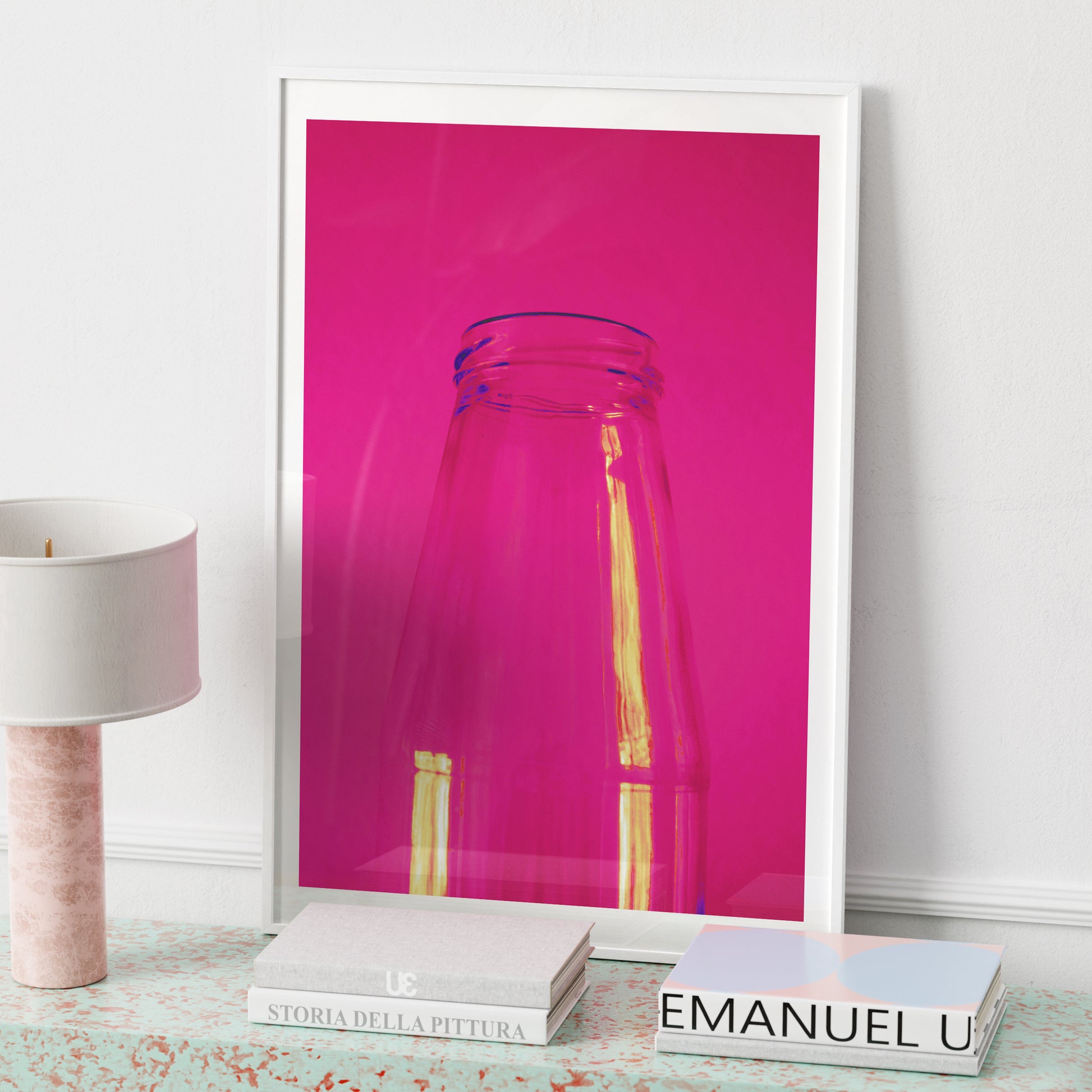 Minimalist intense neon pink art print on a sideboard.