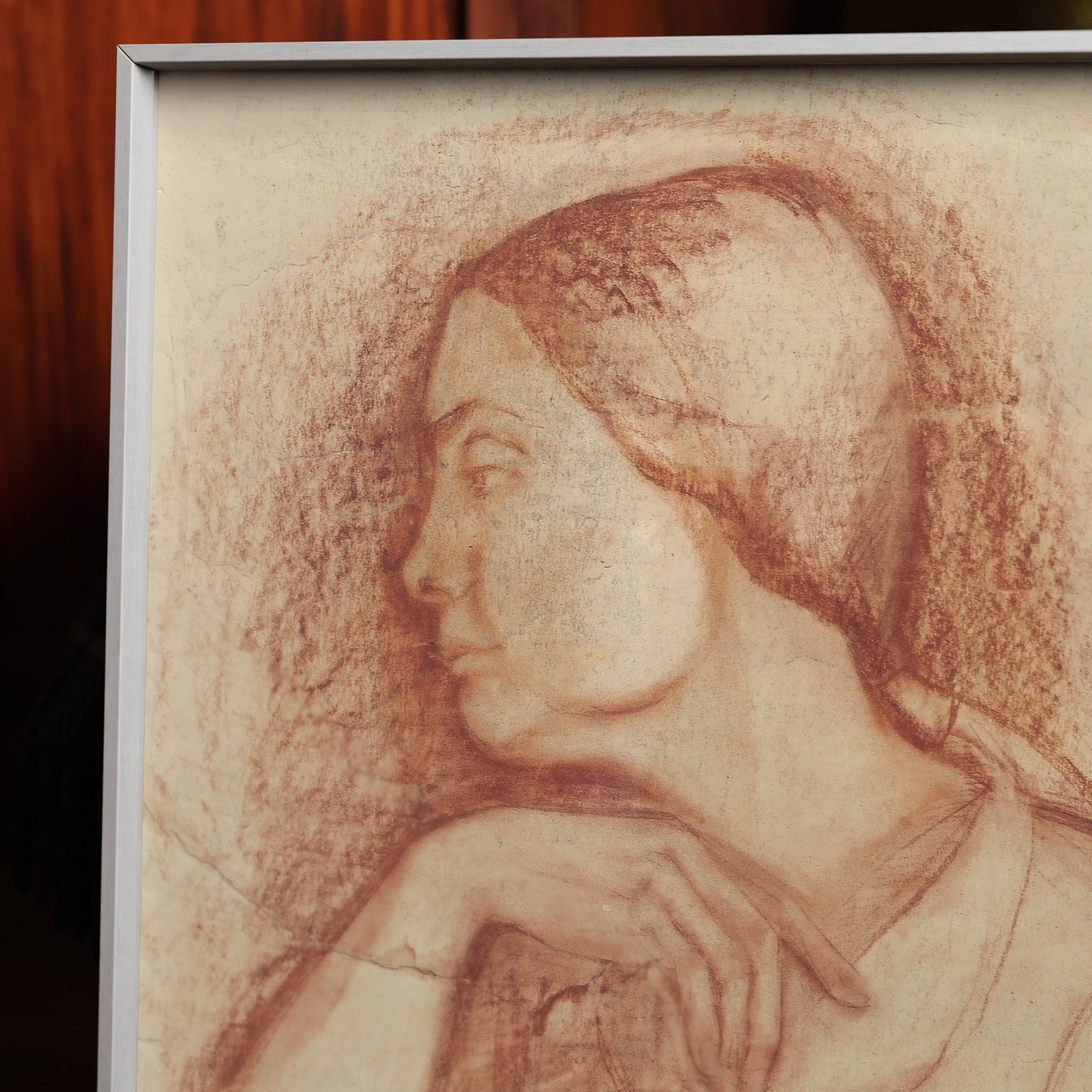 Detail of a framed fine art print depicting a sanguine portrait of a lady.
