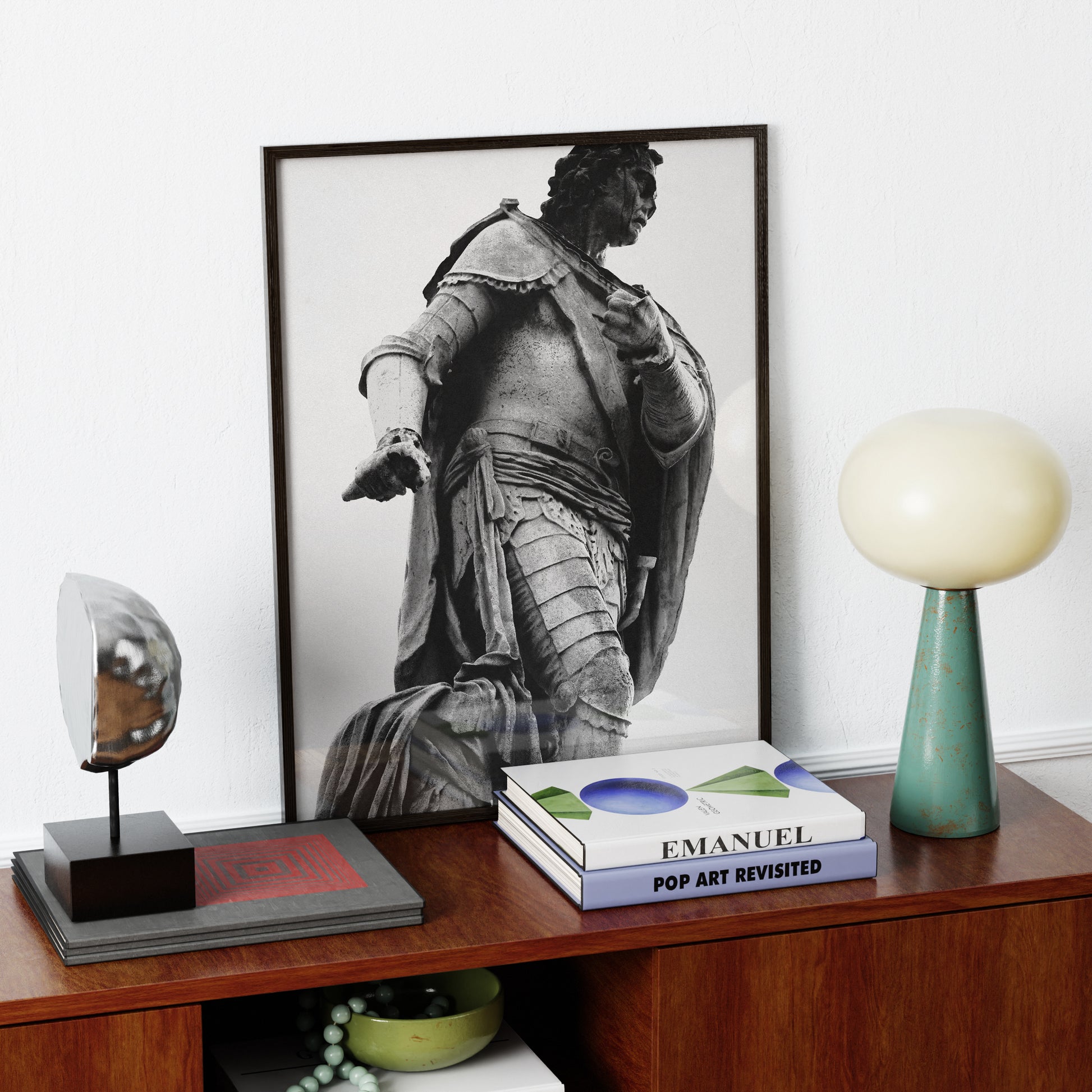 Framed black and white photography art print with a portrait of a classical statue on a wooden shelf with decorative items.