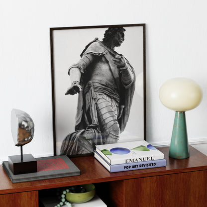 Framed black and white photography art print with a portrait of a classical statue on a wooden shelf with decorative items.