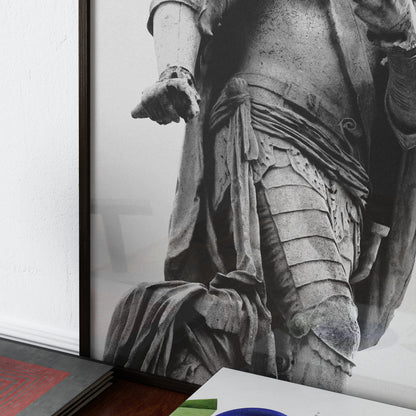 Close-up of a black and white photography art print with a classical statue with detailed drapery and armor.