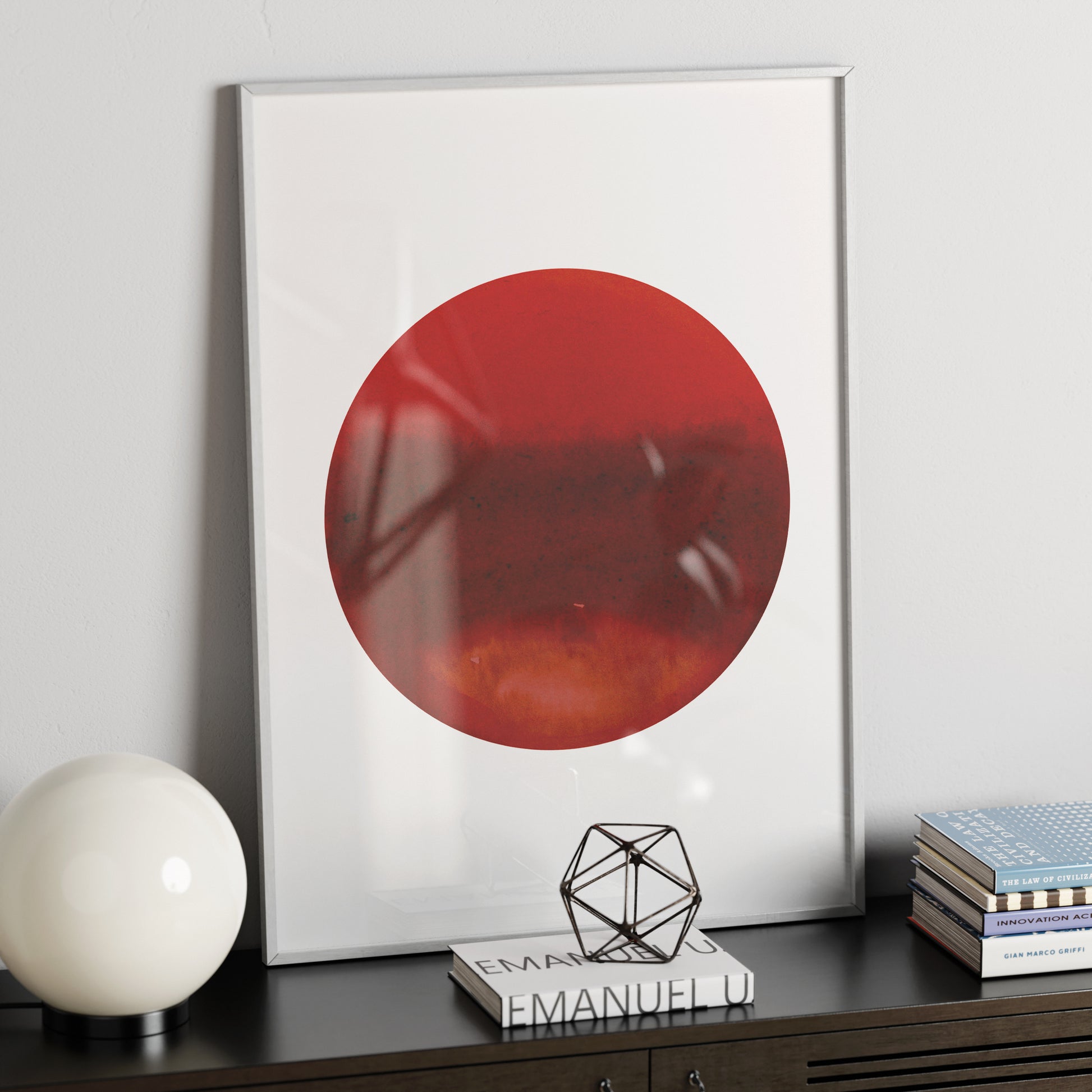 Intense red planet, minimalist watercolor graphic art print on a modern metallic sideboard.