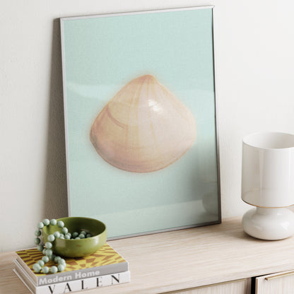 Framed art print of a shell on a shelf with decor items.