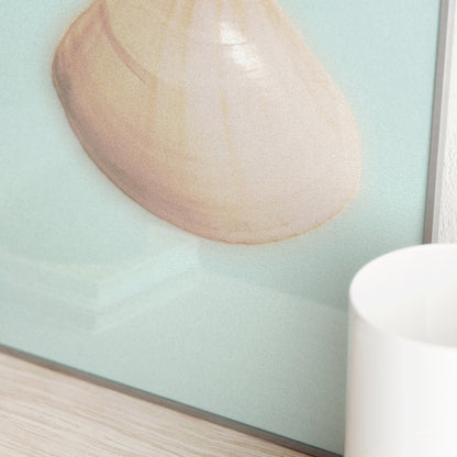 Detail of an art print with a seashell on a light blue surface.