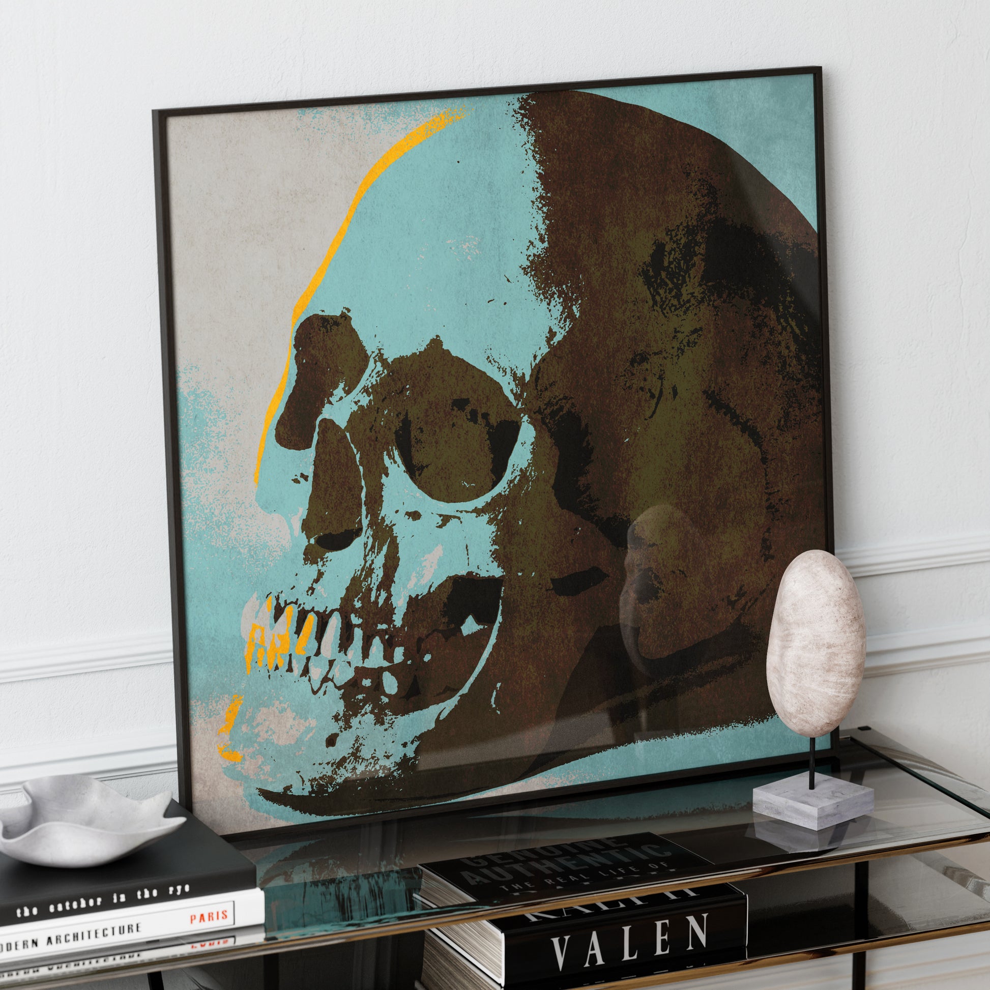 Blue skull pop art art print on a luxury glass sideboard.