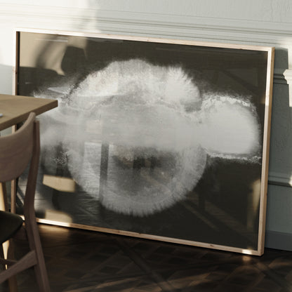 Abstract black and white art print in a wood frame.