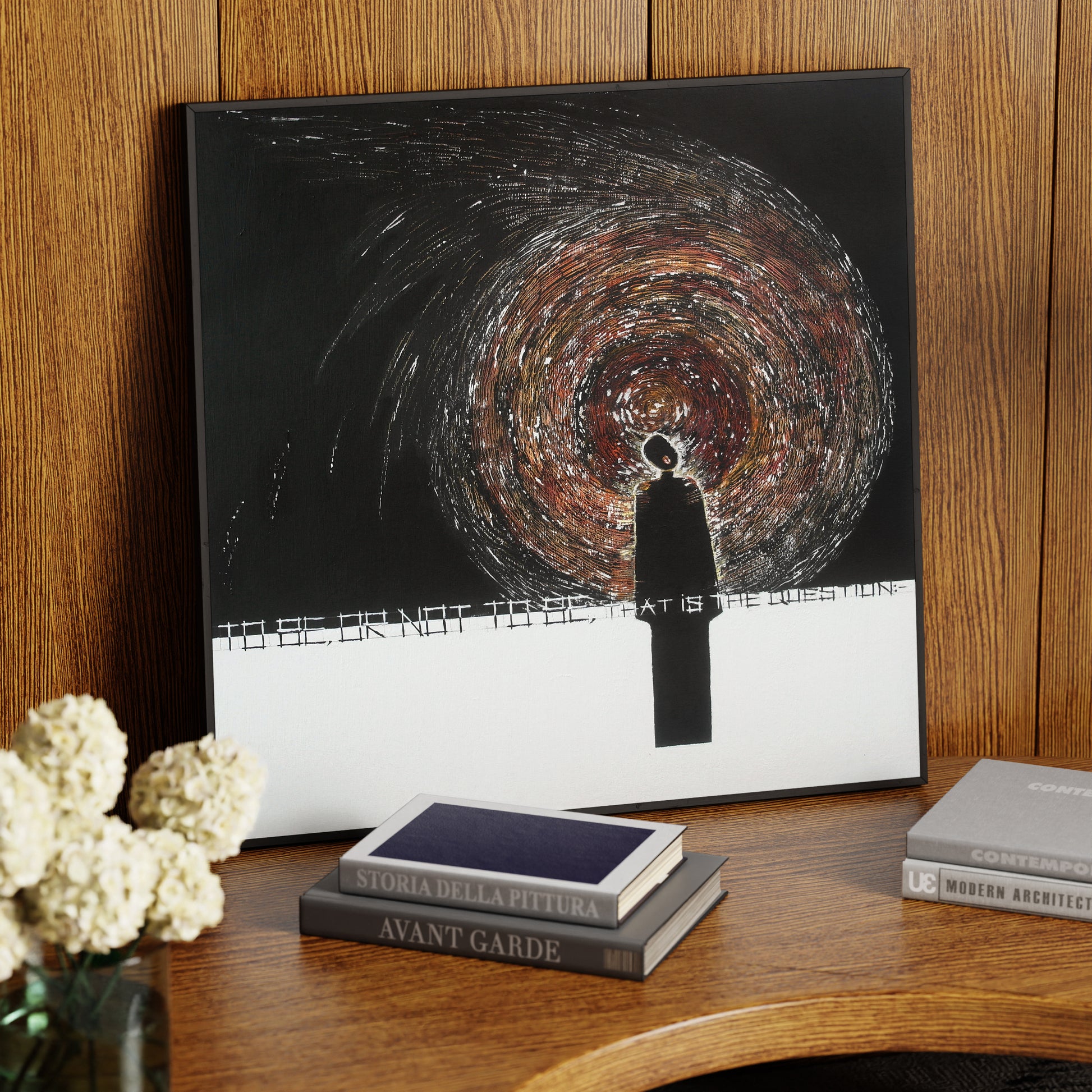 Abstract figurative contemporary painting on a wood table.