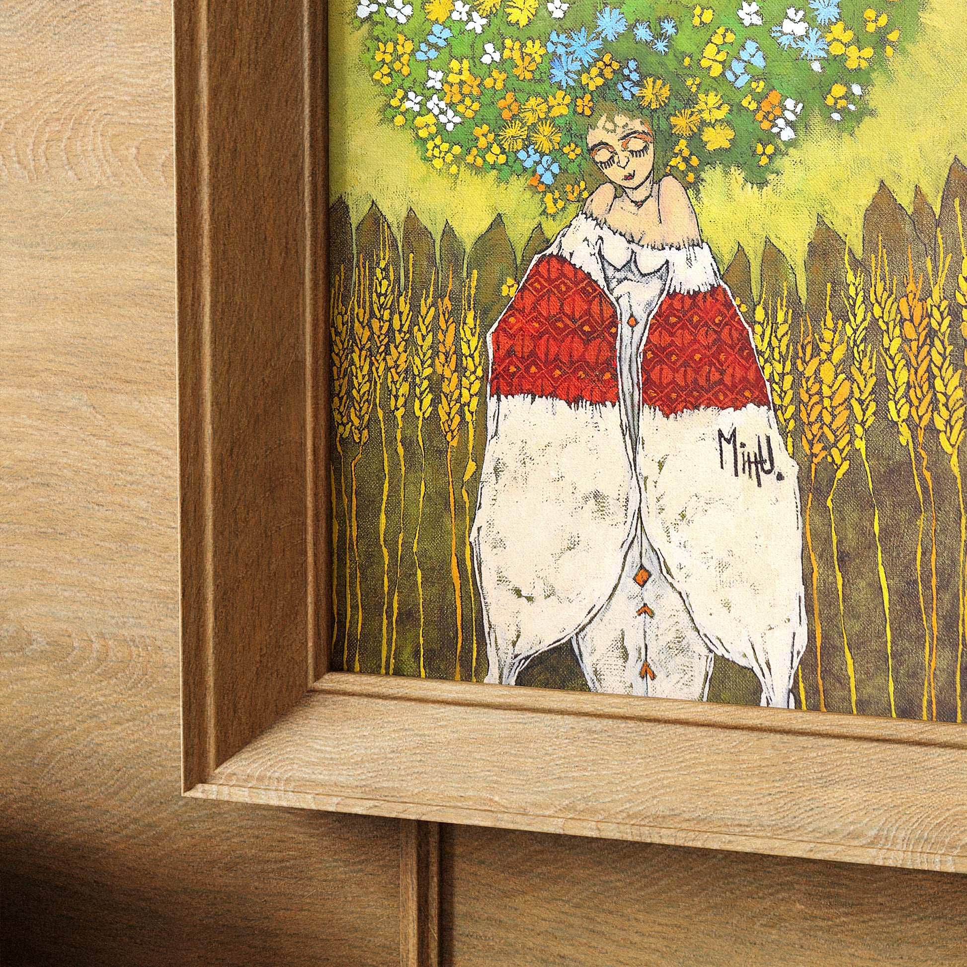 Colorful framed artwork of a woman with flowers in her hair standing against a wooden fence.