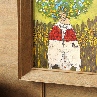 Colorful framed artwork of a woman with flowers in her hair standing against a wooden fence.