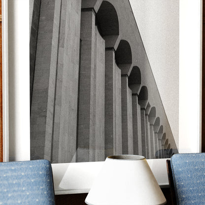 Abstract architectural design with arches and columns in a white frame.
