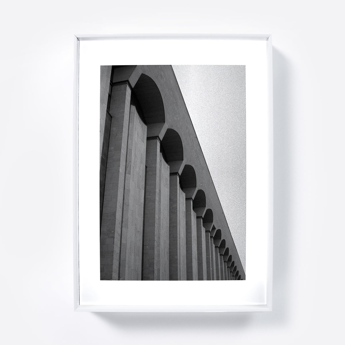 Framed black and white architectural photograph on a white wall