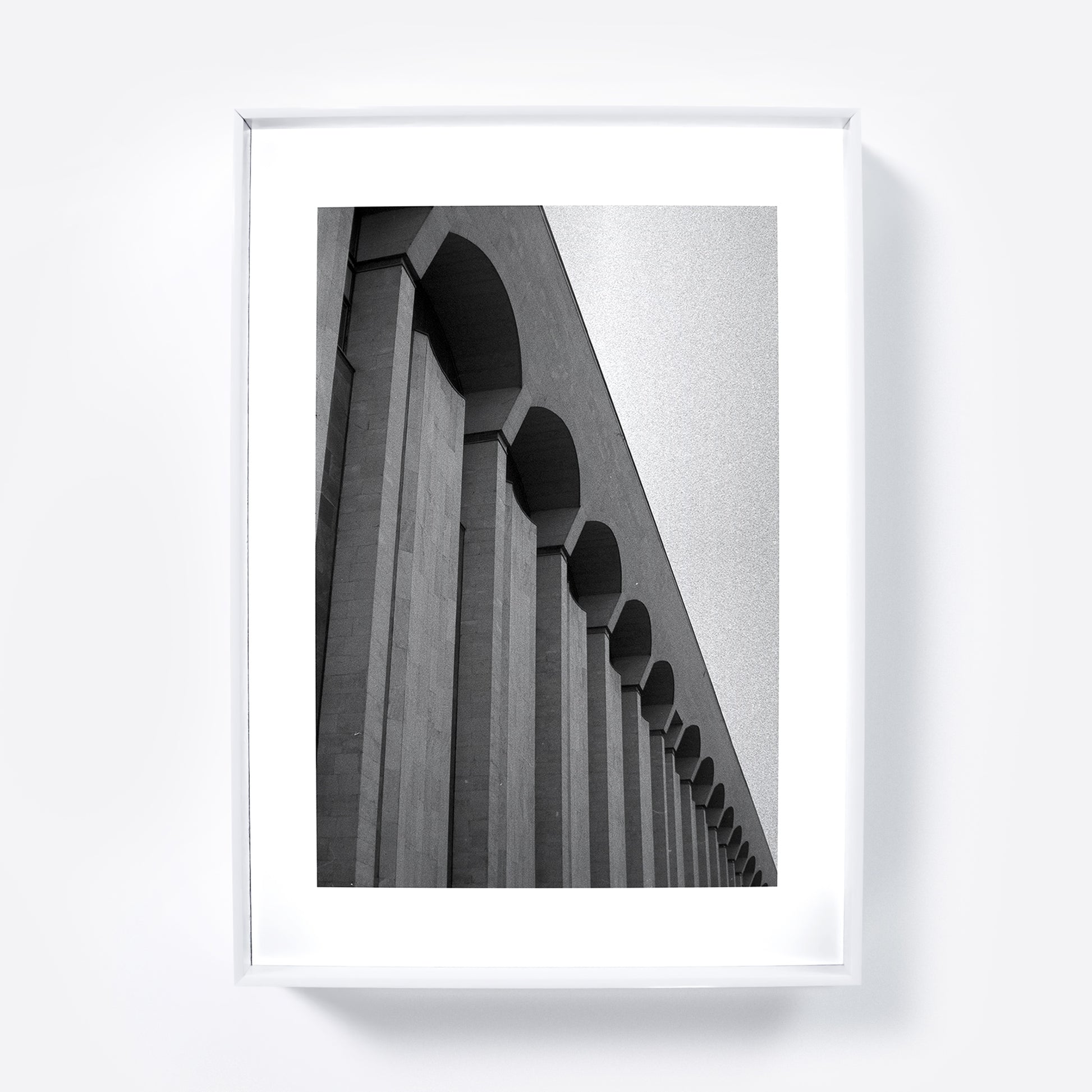 Framed black and white architectural photograph on a white wall