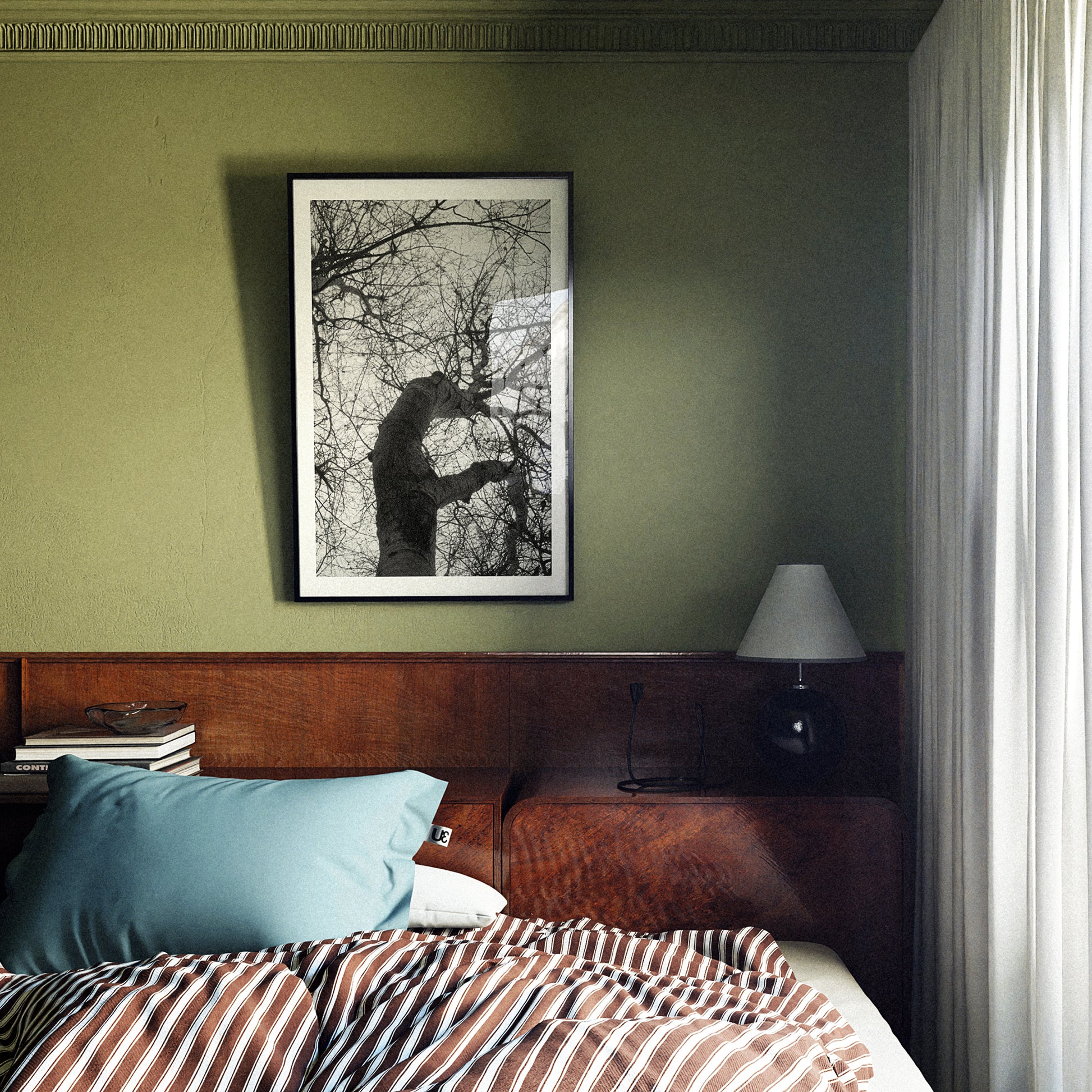 Bedroom with wooden headboard, striped bedding, and framed artwork on green wall.