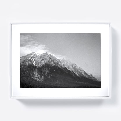 Framed black and white photograph of a mountain range with snow-capped peaks.