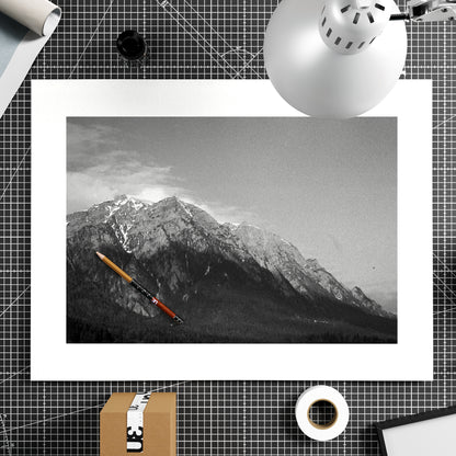 Black and white photo of a mountain with a red pen on a grid background