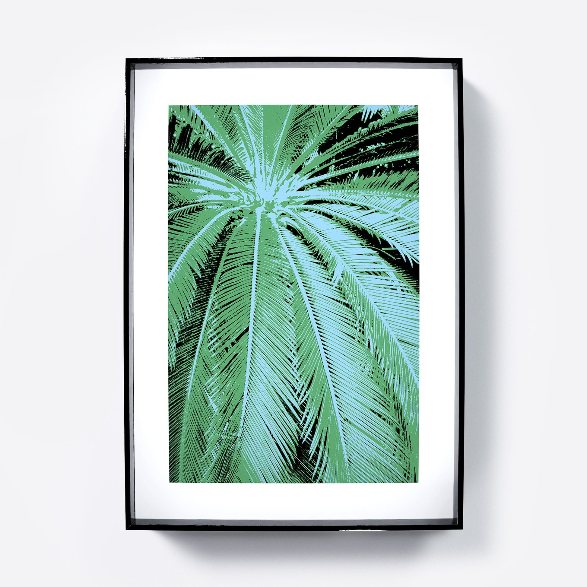 Framed artwork of a palm leaf design on a white background