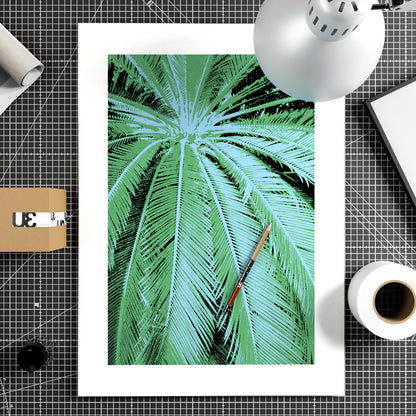 Close-up of a palm leaf with a white border on a light gray background