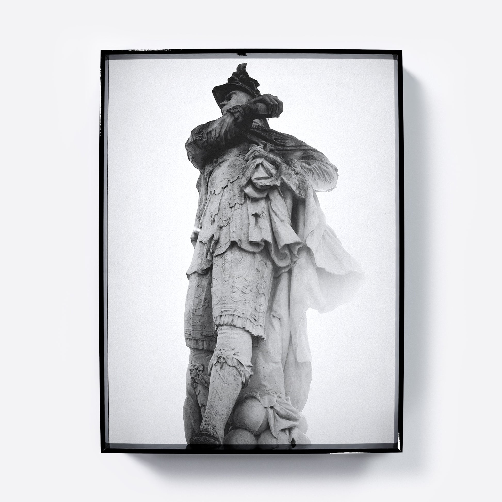 Framed black and white photograph art print of a classical statue against a light gray background.