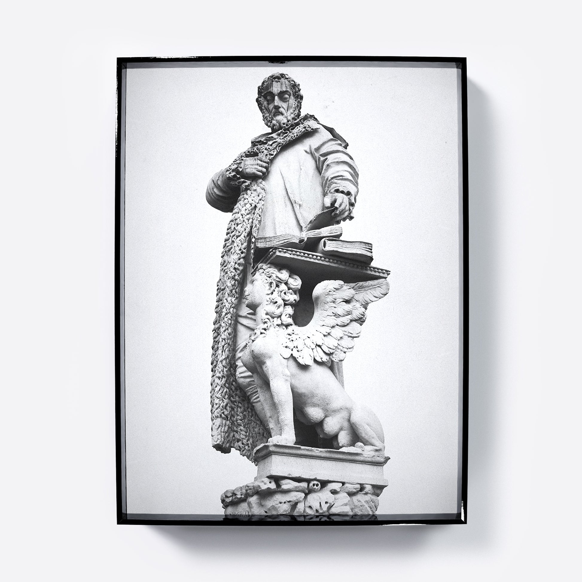 Framed black and white statue print on a white background
