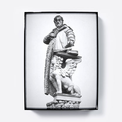 Framed black and white statue print on a white background