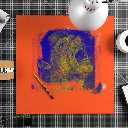 Unframed contemporary art print of a male portrait covered by red paint sitting on a work desk.