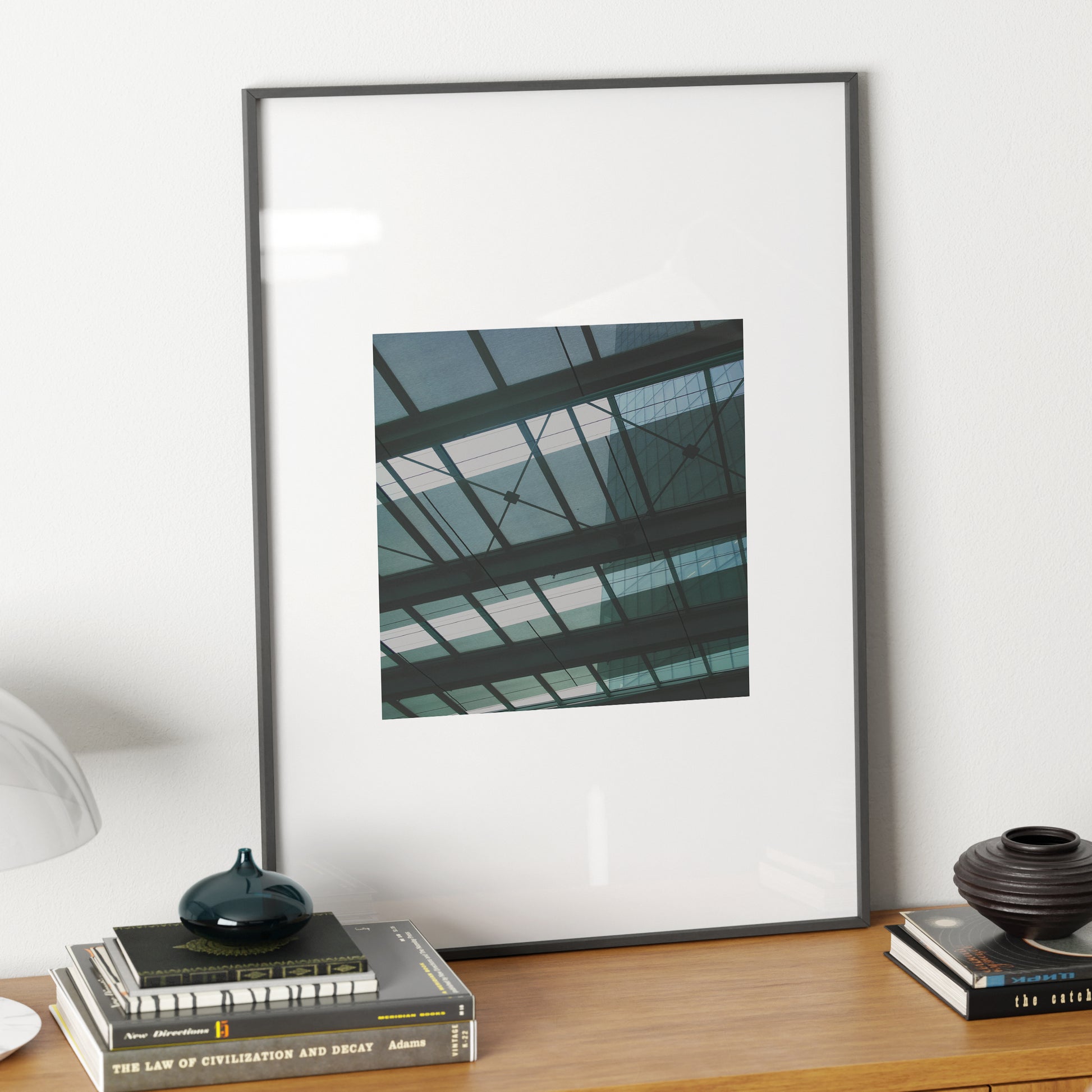 Green, monochrome, modern architectural photography art print on a sideboard.