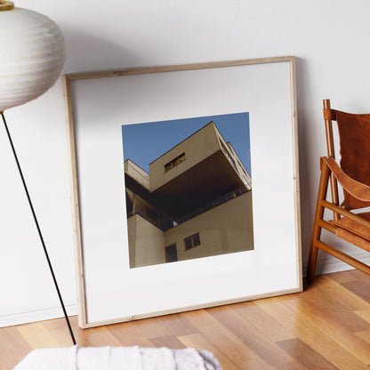 Brutalist, modern architectural corner in Vienna, urban photography art print in a natural wood frame.
